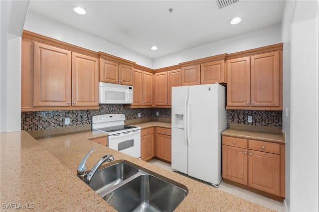 4381 Lazio Way Unit 501, Fort Myers, FL 33901 - kitchen featuring white appliances, a sink, backsplash, recessed lighting, and light stone countertops
