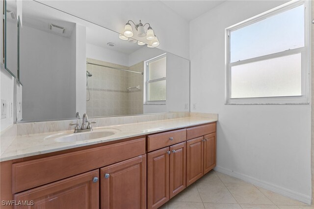 4381 Lazio Way Unit 501, Fort Myers, FL 33901 - full bathroom with vanity, tile patterned flooring, a tile shower, and baseboards