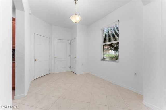 4381 Lazio Way Unit 501, Fort Myers, FL 33901 - unfurnished room featuring baseboards and light tile patterned floors
