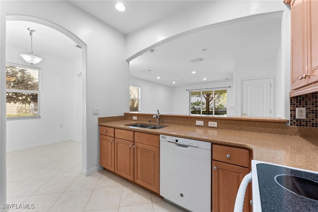 4381 Lazio Way Unit 501, Fort Myers, FL 33901 - kitchen featuring white dishwasher, a sink, arched walkways, light tile patterned floors, and recessed lighting