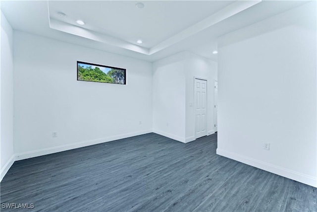 352 Rawlings Ave, Lehigh Acres, FL 33974 - unfurnished room with recessed lighting, dark wood-type flooring, baseboards, and a tray ceiling