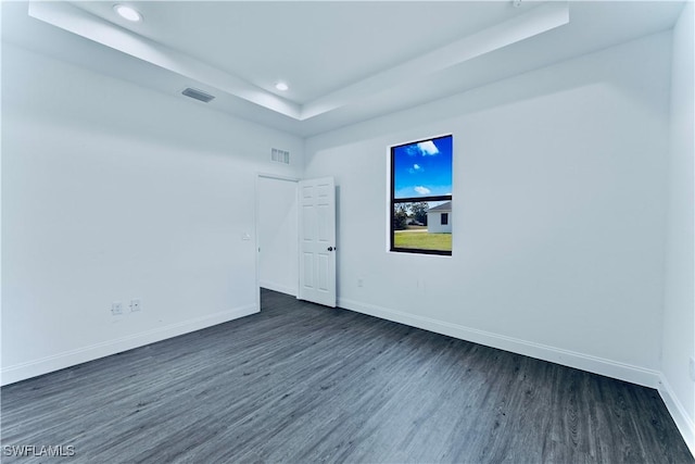 352 Rawlings Ave, Lehigh Acres, FL 33974 - spare room with a tray ceiling, dark wood finished floors, baseboards, and recessed lighting