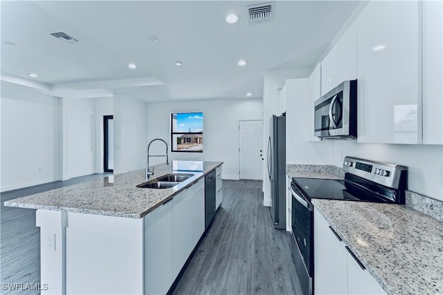 352 Rawlings Ave, Lehigh Acres, FL 33974 - kitchen featuring appliances with stainless steel finishes, a sink, white cabinets, a center island with sink, and dark wood-style floors