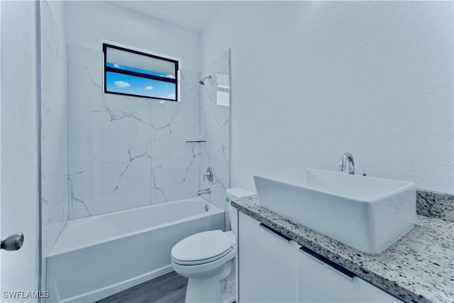 352 Rawlings Ave, Lehigh Acres, FL 33974 - full bath featuring toilet, vanity, shower / washtub combination, and wood finished floors