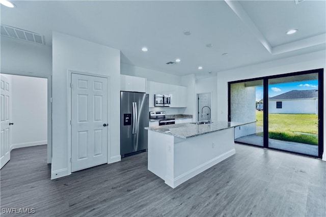 352 Rawlings Ave, Lehigh Acres, FL 33974 - kitchen featuring appliances with stainless steel finishes, white cabinets, a sink, dark wood-type flooring, and an island with sink