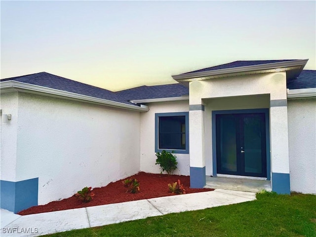 352 Rawlings Ave, Lehigh Acres, FL 33974 - entrance to property with stucco siding, roof with shingles, and french doors