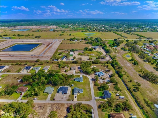 352 Rawlings Ave, Lehigh Acres, FL 33974 - aerial overview of property's location with a nearby body of water and nearby suburban area