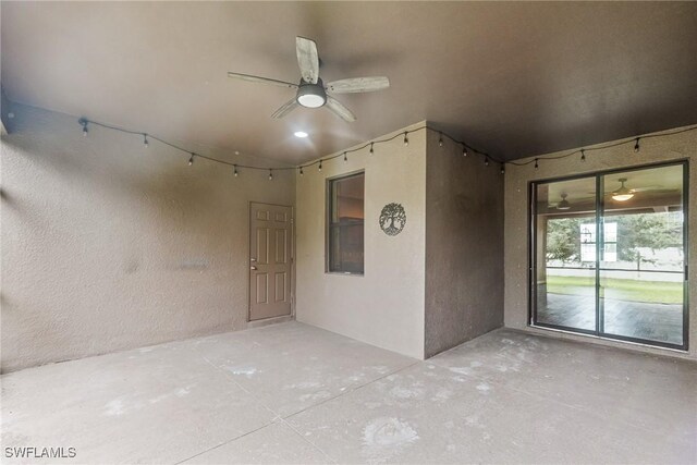 2211 SW 12th Ln, Cape Coral, FL 33991 - unfurnished room with unfinished concrete flooring, a textured wall, and ceiling fan