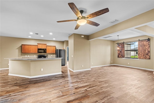 2211 SW 12th Ln, Cape Coral, FL 33991 - kitchen featuring black microwave, freestanding refrigerator, range, light wood-style floors, and recessed lighting