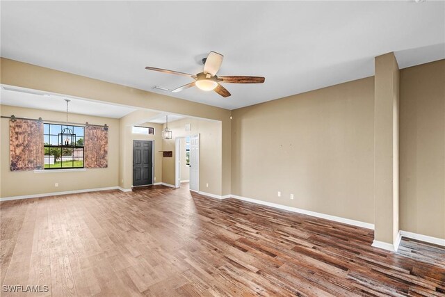 2211 SW 12th Ln, Cape Coral, FL 33991 - unfurnished living room with wood finished floors and ceiling fan