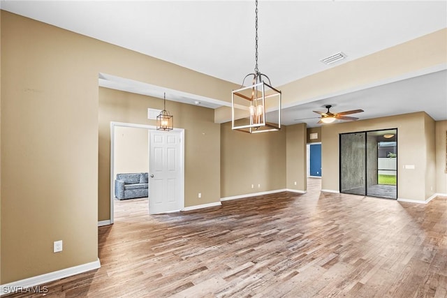 2211 SW 12th Ln, Cape Coral, FL 33991 - unfurnished room featuring wood finished floors, ceiling fan, and a chandelier