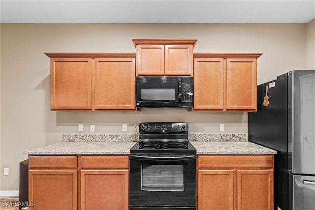 2211 SW 12th Ln, Cape Coral, FL 33991 - kitchen featuring black appliances and light stone counters