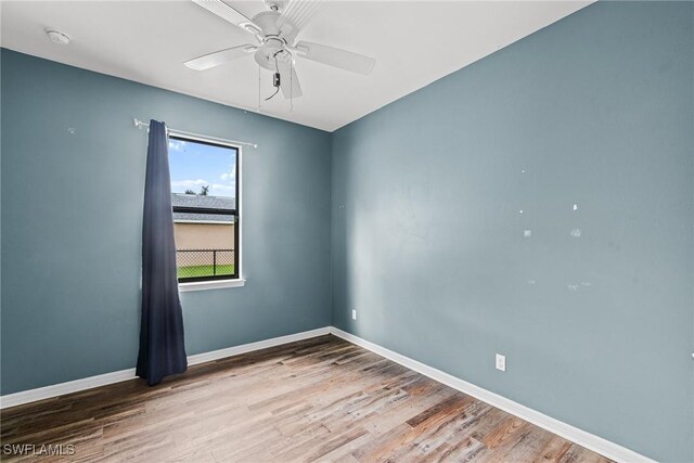 2211 SW 12th Ln, Cape Coral, FL 33991 - unfurnished room featuring wood finished floors, ceiling fan, and a smoke detector