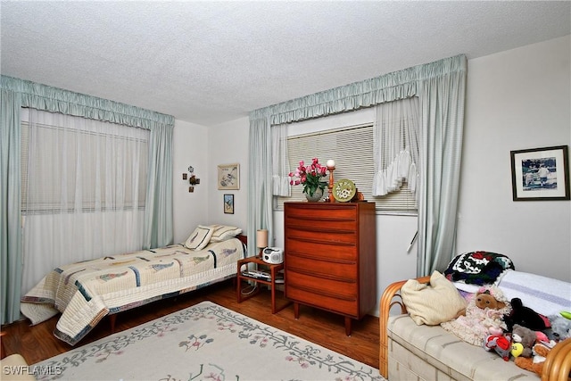104 Waterview Ave, Lehigh Acres, FL 33936 - bedroom featuring wood finished floors and a textured ceiling