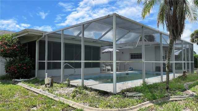 104 Waterview Ave, Lehigh Acres, FL 33936 - back of house with an outdoor pool, glass enclosure, and a patio