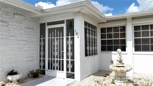 104 Waterview Ave, Lehigh Acres, FL 33936 - doorway to property featuring stucco siding