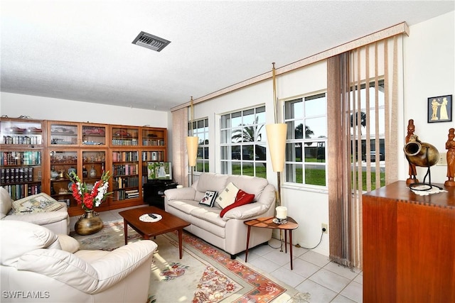 104 Waterview Ave, Lehigh Acres, FL 33936 - living area featuring light tile patterned floors and a textured ceiling