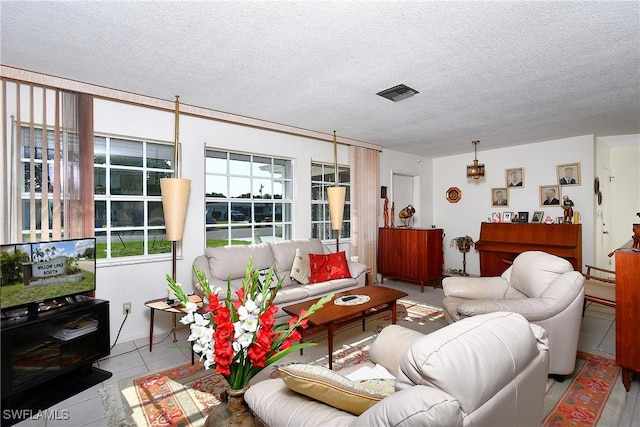 104 Waterview Ave, Lehigh Acres, FL 33936 - living room featuring a textured ceiling and tile patterned floors