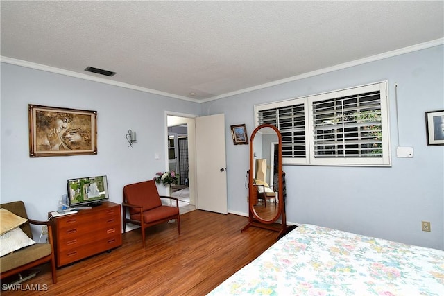 104 Waterview Ave, Lehigh Acres, FL 33936 - bedroom with wood finished floors, ornamental molding, and a textured ceiling