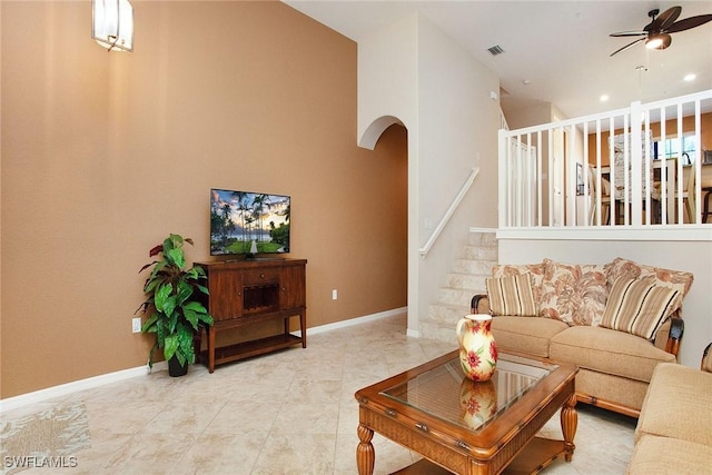 9065 Albion Ln N Unit 4909, Naples, FL 34113 - living area with a ceiling fan, arched walkways, and stairway