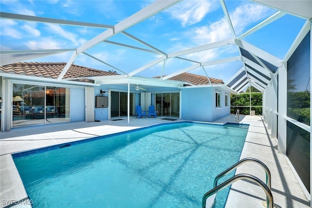 53 Madagascar Ct, Marco Island, FL 34145 - back of house featuring a tile roof, a patio, an outdoor pool, stucco siding, and glass enclosure