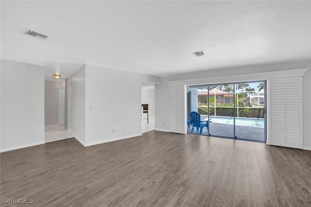 53 Madagascar Ct, Marco Island, FL 34145 - unfurnished living room featuring wood finished floors and baseboards