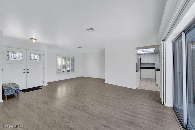 53 Madagascar Ct, Marco Island, FL 34145 - unfurnished living room featuring light wood-style flooring and baseboards