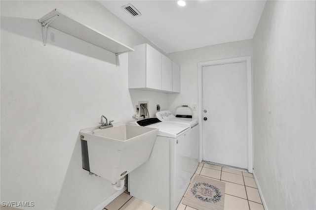 53 Madagascar Ct, Marco Island, FL 34145 - laundry room with cabinet space, washing machine and dryer, and light tile patterned floors
