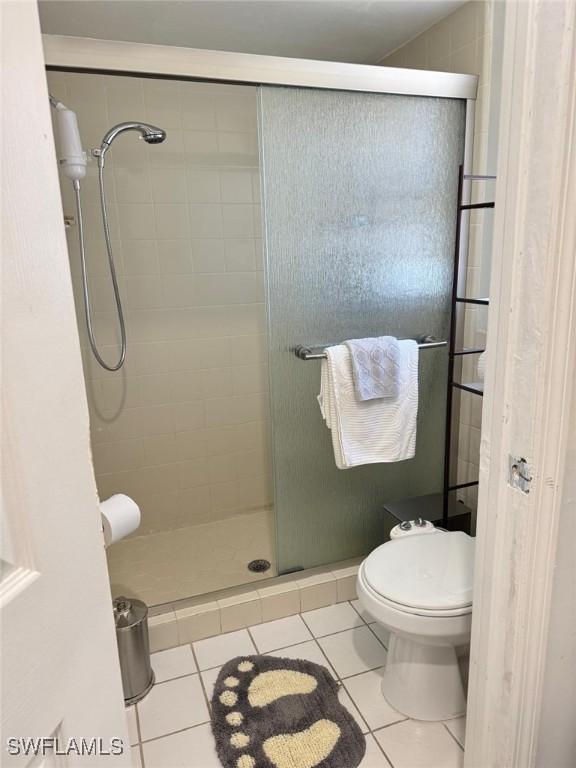 4090 32nd Ave SW, Naples, FL 34116 - full bathroom featuring tile patterned flooring, a stall shower, and toilet