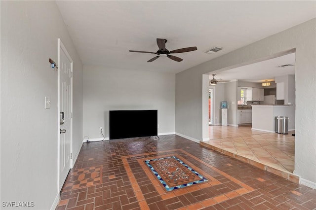 3018 Sunset Rd, Fort Myers, FL 33901 - unfurnished living room featuring a ceiling fan and brick patterned flooring