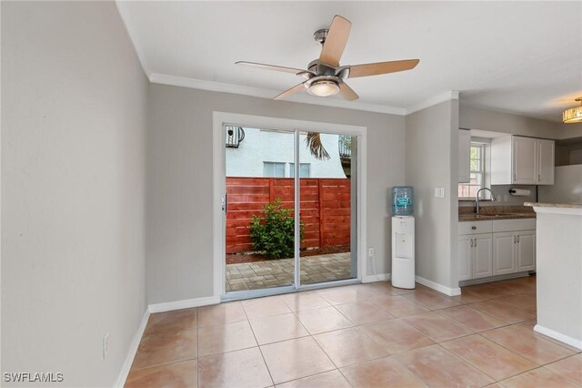 3018 Sunset Rd, Fort Myers, FL 33901 - kitchen featuring white cabinetry, ceiling fan, ornamental molding, and light tile patterned floors
