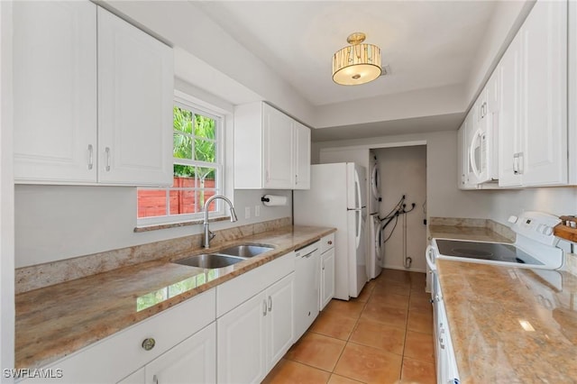 3018 Sunset Rd, Fort Myers, FL 33901 - kitchen featuring white appliances, white cabinetry, light tile patterned flooring, and light stone countertops