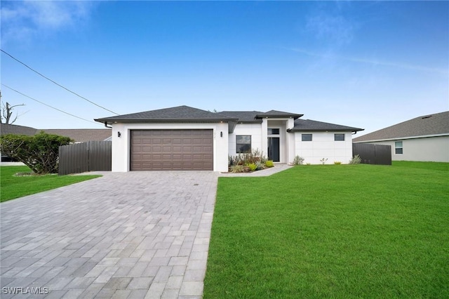 1921 SW 4th St, Cape Coral, FL 33991 - prairie-style house featuring an attached garage, decorative driveway, and stucco siding