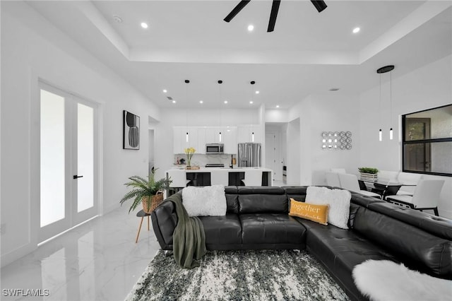 1921 SW 4th St, Cape Coral, FL 33991 - living room with ceiling fan, recessed lighting, light marble finish floors, and a raised ceiling