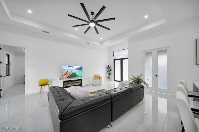 1921 SW 4th St, Cape Coral, FL 33991 - living room featuring a tray ceiling, french doors, recessed lighting, light marble finish floors, and ceiling fan