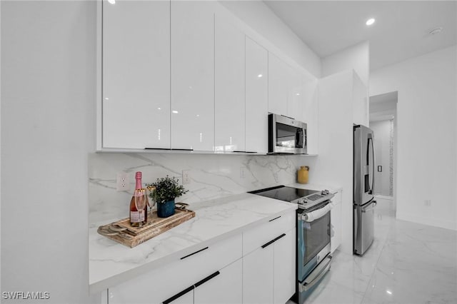 1921 SW 4th St, Cape Coral, FL 33991 - kitchen with stainless steel appliances, modern cabinets, white cabinetry, and recessed lighting