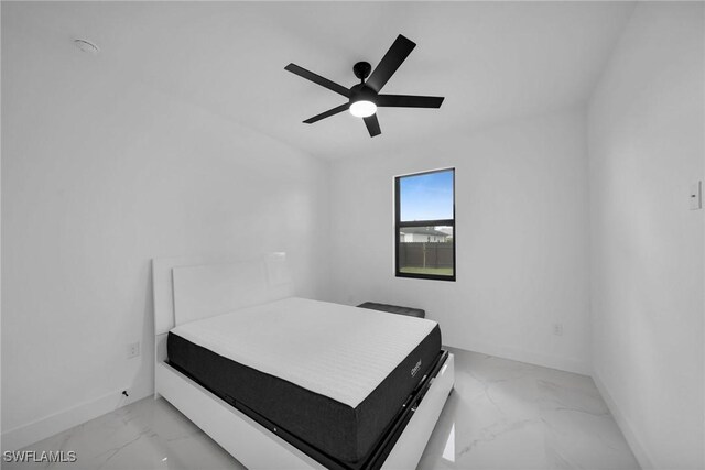 1921 SW 4th St, Cape Coral, FL 33991 - bedroom with light marble finish flooring, baseboards, and ceiling fan