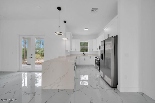 1205 W 14th St, Lehigh Acres, FL 33972 - kitchen with appliances with stainless steel finishes, light marble finish flooring, a sink, and a peninsula