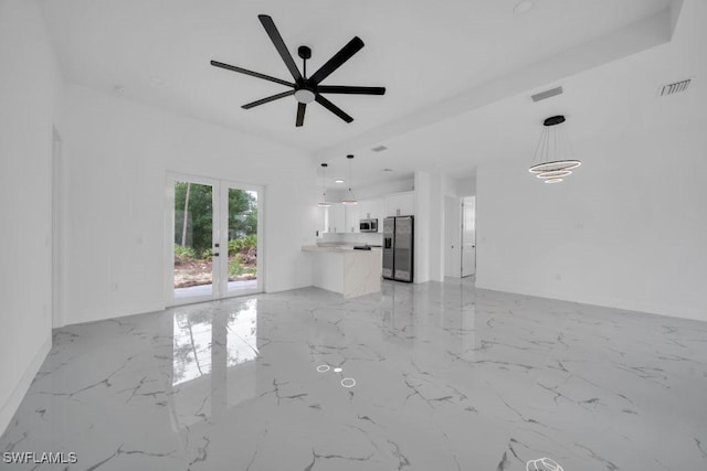 1205 W 14th St, Lehigh Acres, FL 33972 - unfurnished living room featuring light marble finish flooring, a ceiling fan, and french doors