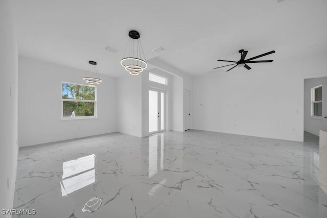 1205 W 14th St, Lehigh Acres, FL 33972 - unfurnished living room featuring marble finish floors, a ceiling fan, and a chandelier