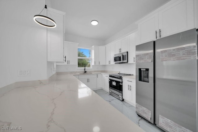 1205 W 14th St, Lehigh Acres, FL 33972 - kitchen featuring appliances with stainless steel finishes, white cabinets, light stone counters, a sink, and light marble finish flooring