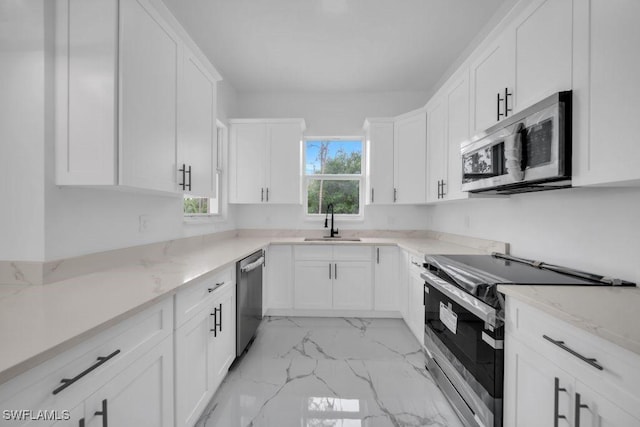 1205 W 14th St, Lehigh Acres, FL 33972 - kitchen with stainless steel appliances, a sink, light marble finish floors, and white cabinets