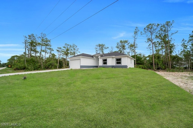 1205 W 14th St, Lehigh Acres, FL 33972 - view of front of house featuring stucco siding, a garage, driveway, and a front lawn