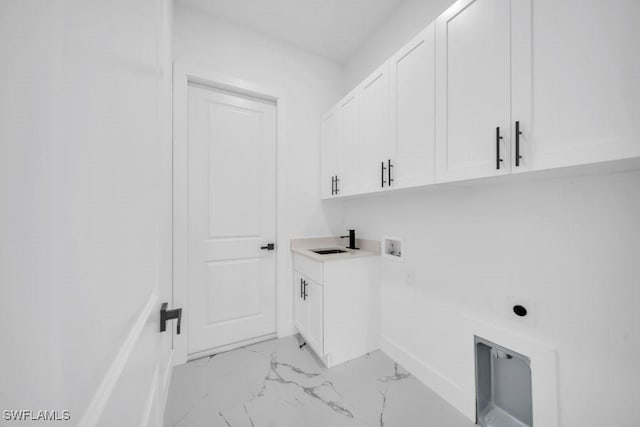 1205 W 14th St, Lehigh Acres, FL 33972 - washroom with cabinet space, electric dryer hookup, washer hookup, light marble finish floors, and baseboards