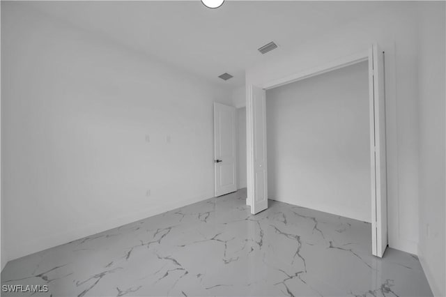 1205 W 14th St, Lehigh Acres, FL 33972 - unfurnished bedroom featuring marble look tile flooring