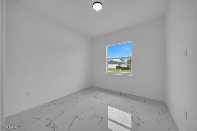 1205 W 14th St, Lehigh Acres, FL 33972 - spare room featuring marble finish flooring
