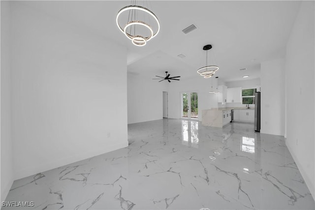 1205 W 14th St, Lehigh Acres, FL 33972 - unfurnished living room with a chandelier, light marble finish floors, and ceiling fan
