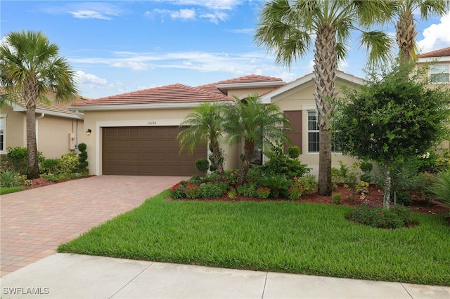 16126 Rosemallow Ln, Alva, FL 33920 - mediterranean / spanish-style house featuring decorative driveway, a garage, stucco siding, and a front yard