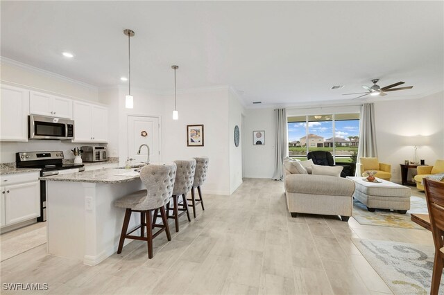 16126 Rosemallow Ln, Alva, FL 33920 - kitchen with appliances with stainless steel finishes, a sink, open floor plan, white cabinetry, and crown molding