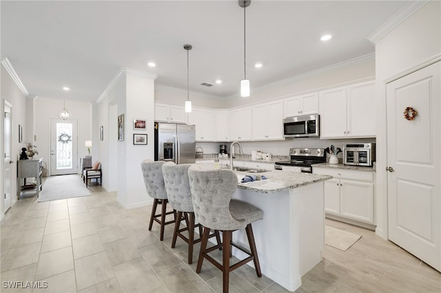16126 Rosemallow Ln, Alva, FL 33920 - kitchen with appliances with stainless steel finishes, a sink, ornamental molding, a breakfast bar area, and a center island with sink